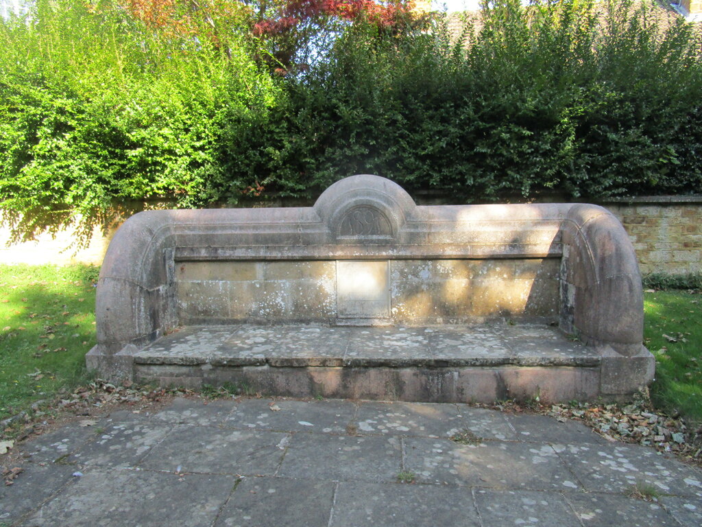 The 1589 village well, now a stone seat, in the middle of the main street